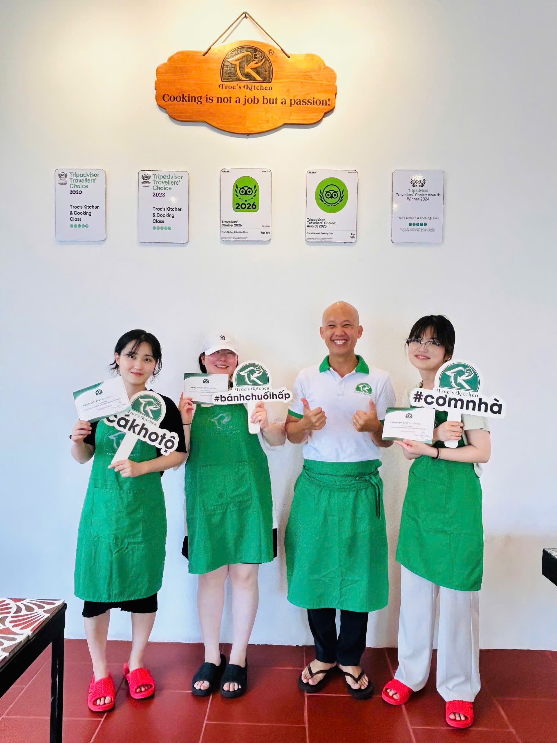 Guests holding finished dishes at Troc's Kitchen cooking class